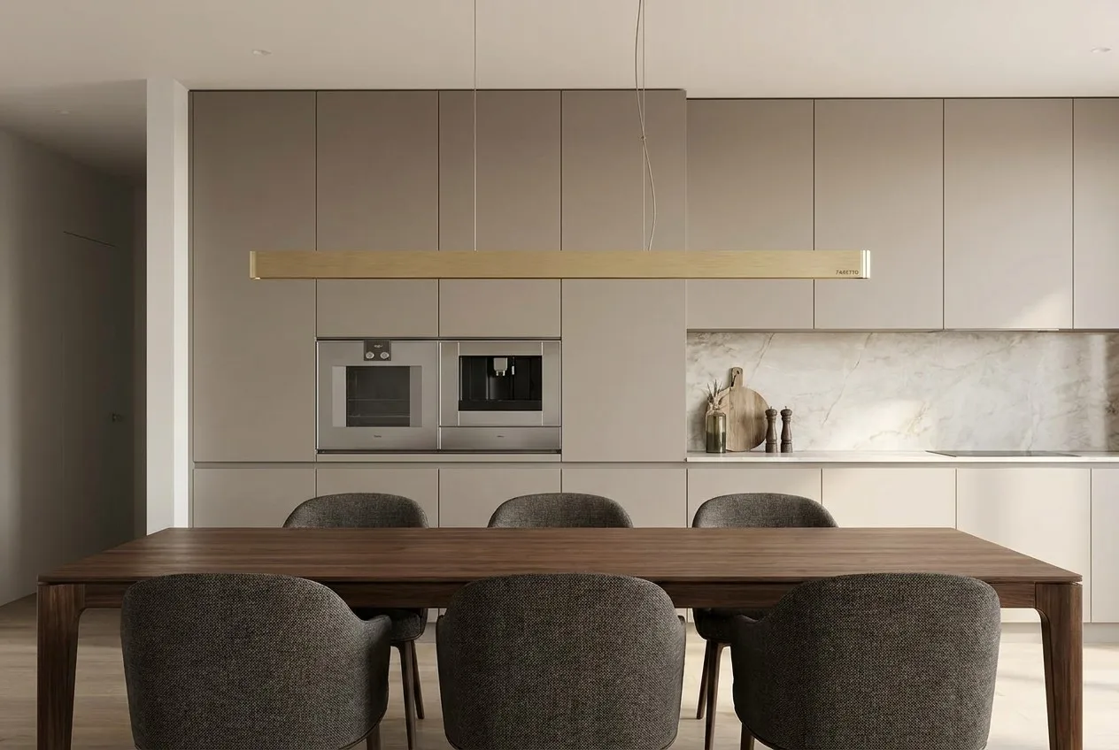 Modern minimalist dining area with a Faretto Linear Pendant Light in gold finish
