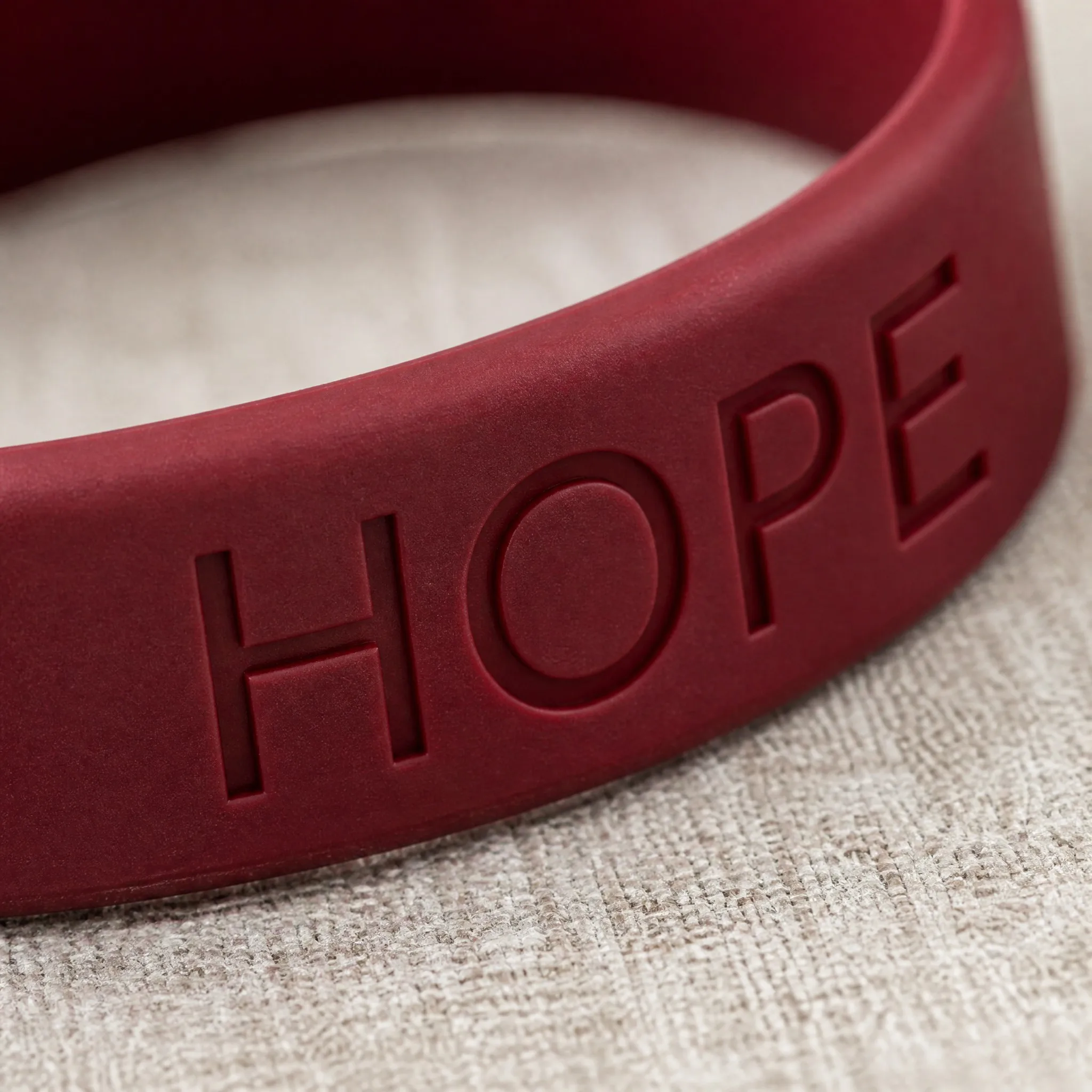 Macro detail of debossed lettering on silicone bracelet
