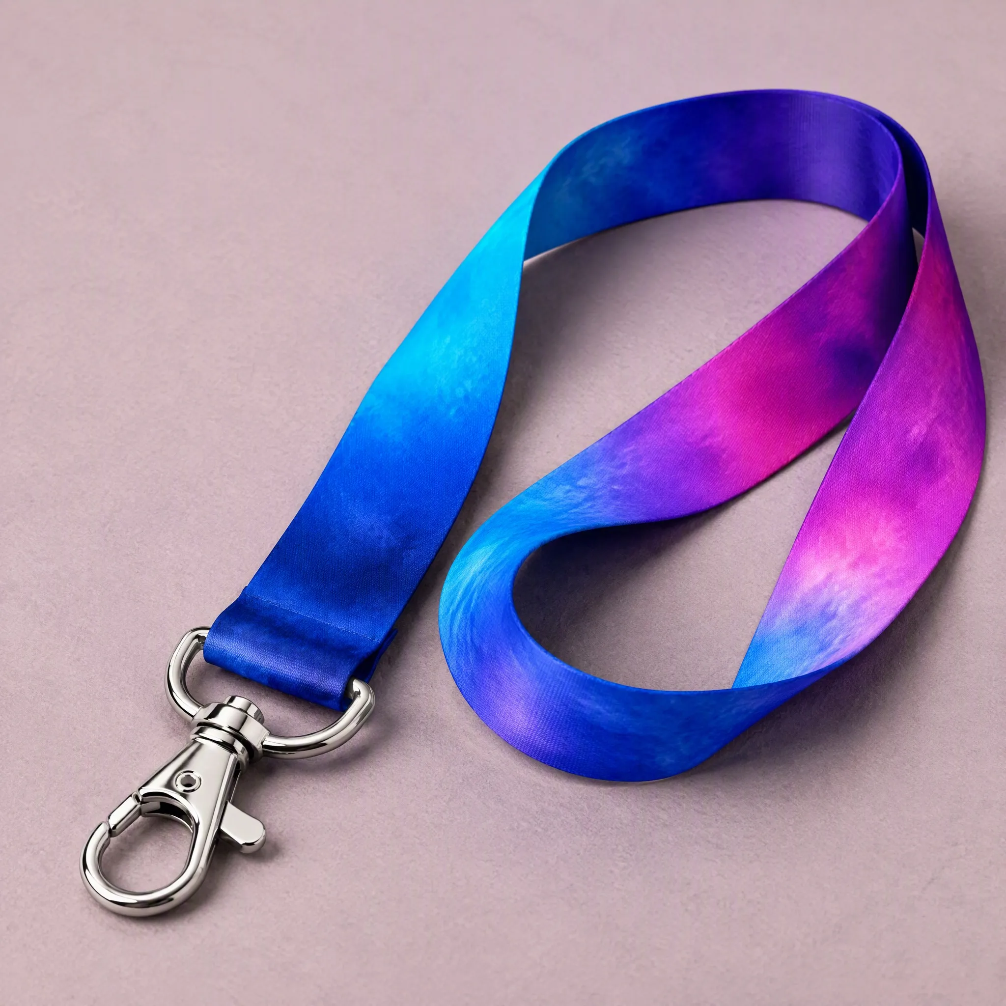 Neat loop of gradient lanyard showing lobster claw clip, swivel base and D-ring