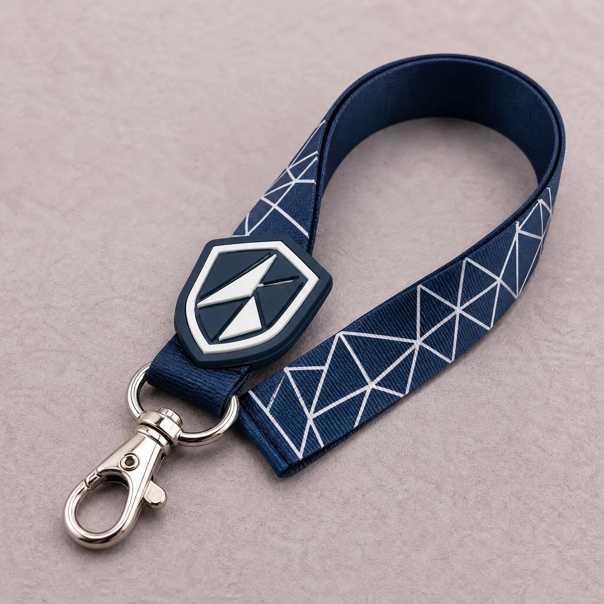 Neat loop of 3D logo lanyard showing lobster claw clip, D-ring and raised emblem