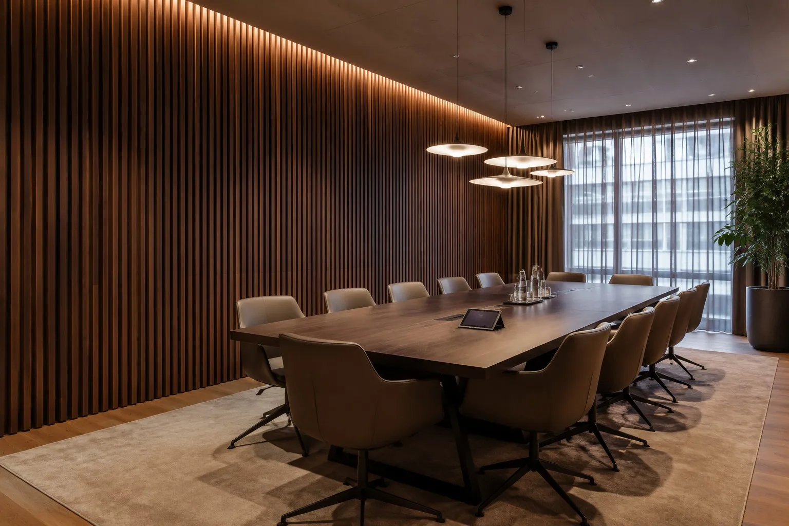Modern corporate meeting room with smoke walnut wood slat acoustic panels as feature wall, conference table, pendant lighting
