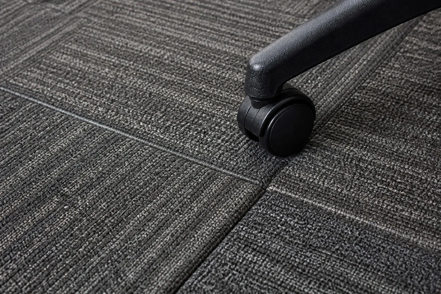 Close-up of office carpet tile seams and low-pile modular construction