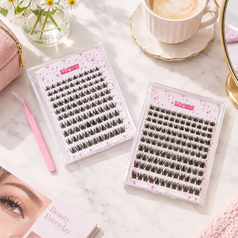 Lifestyle flat lay of two cased segment lash cards with pink printed cards and a pink lash tweezer beside them, with a coffee cup, flowers and a magazine on a marble surface - lash card with tweezers