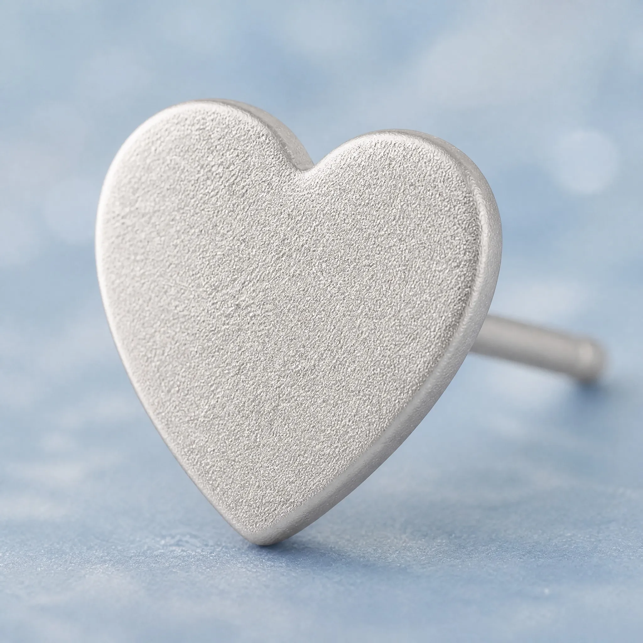 Sandblasted heart earring macro detail