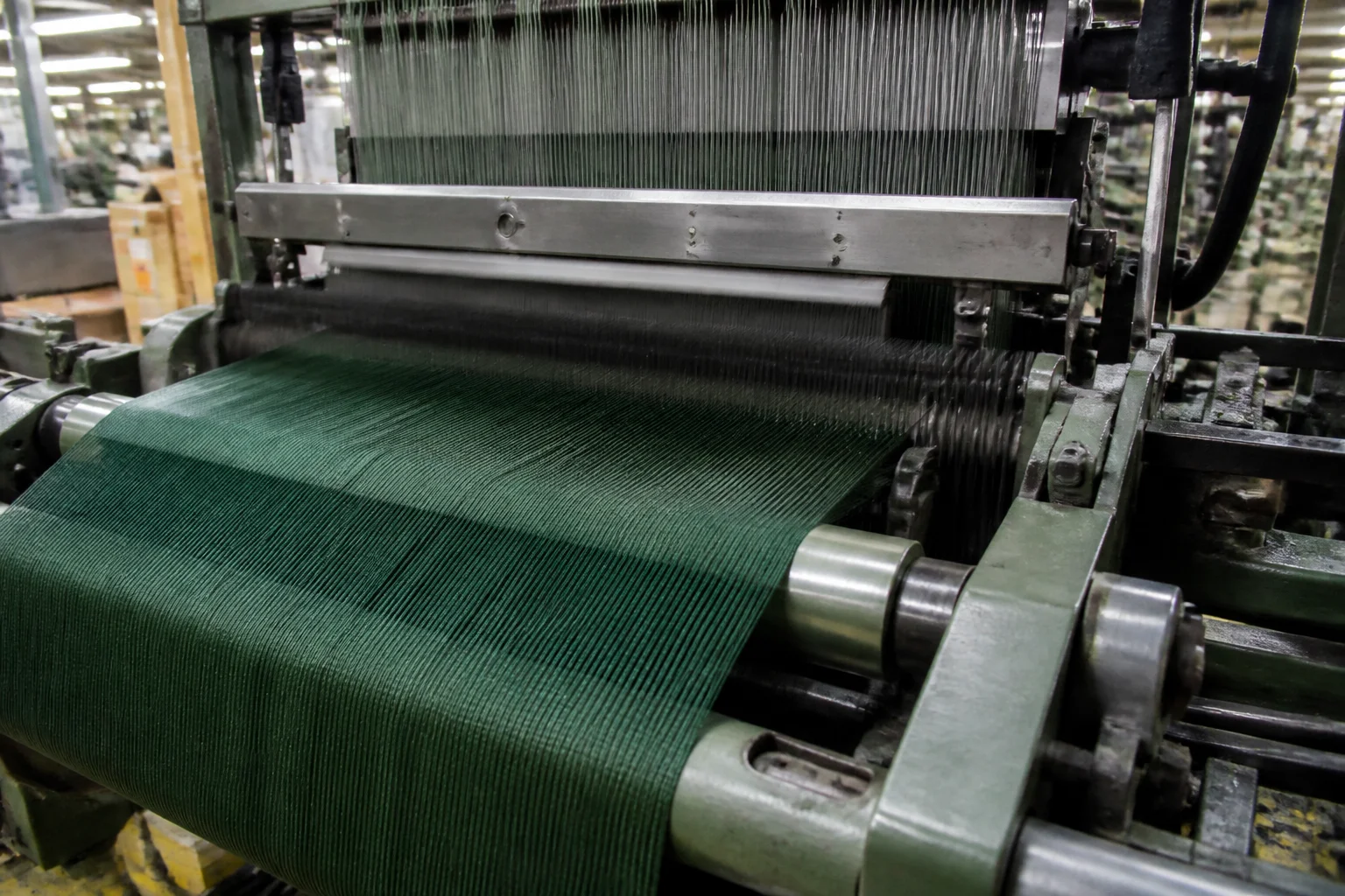 Ribbon loom producing grosgrain ribbon showing weft thread beating mechanism creating rib texture