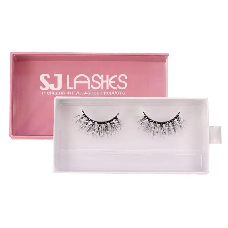 Pale formed paper tray for lashes with a pair on it and a white pull tab, set against the open pink box with white brand wordmark - paper tray lash insert