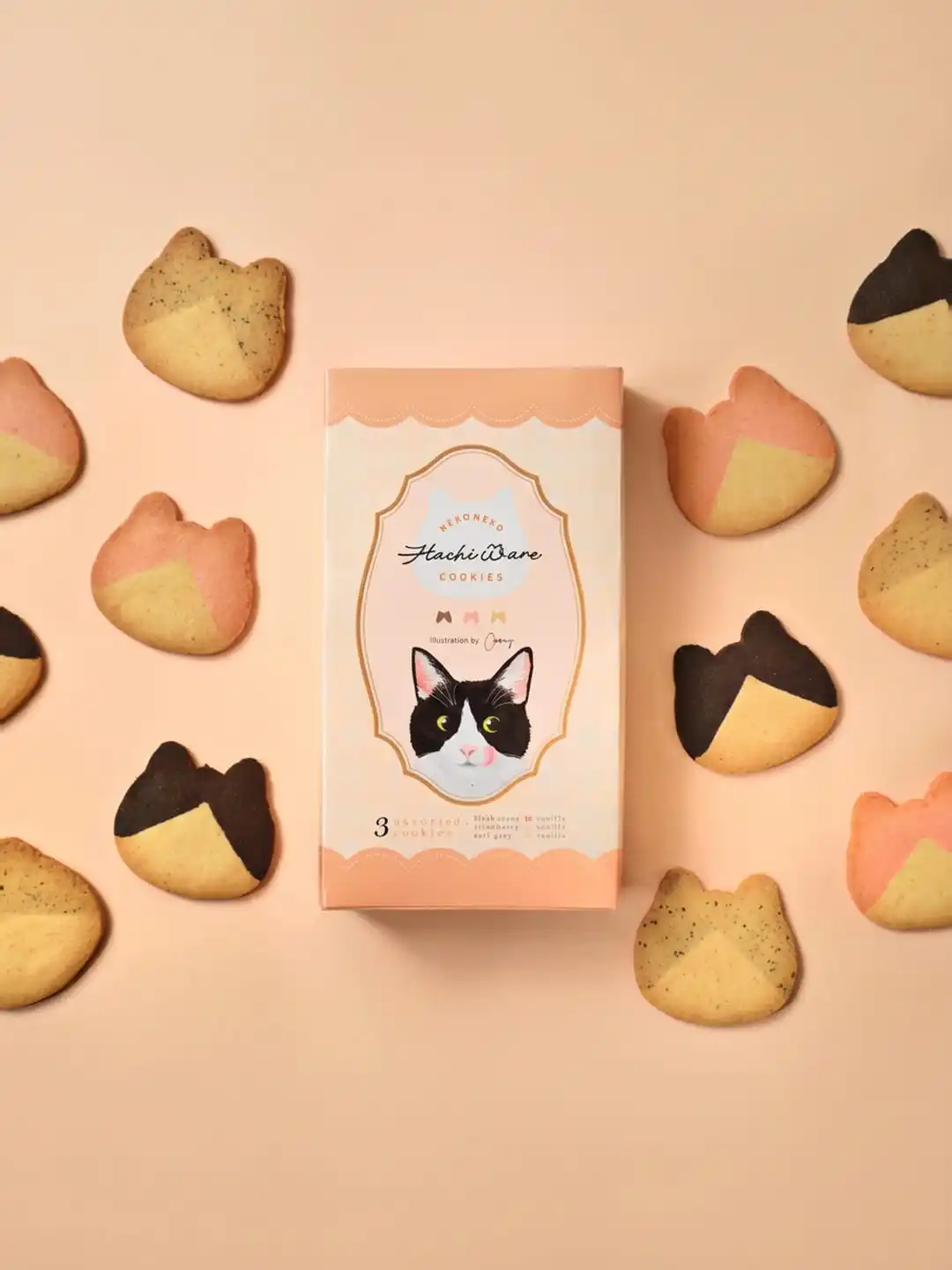 NEKO NEKO HachiWare cookies box surrounded by two-tone cat-shaped cookies on a peach background