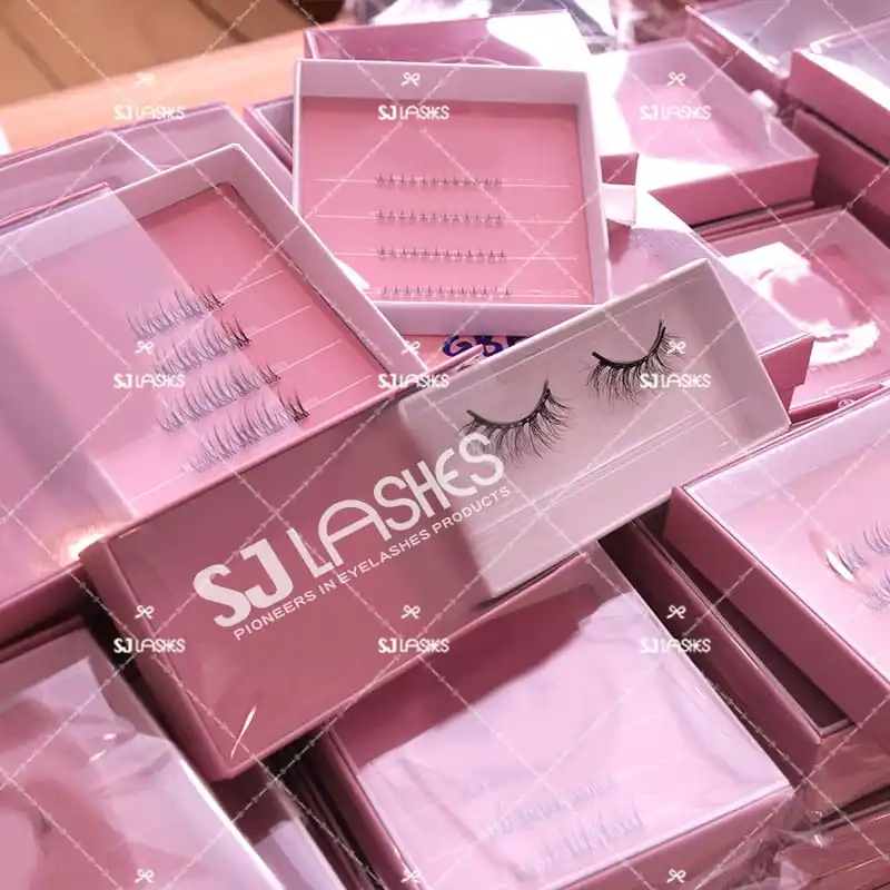 Bulk array of pink slide out lash boxes during production, drawers open showing printed lash cards and pale tray inserts - slide out lash box production