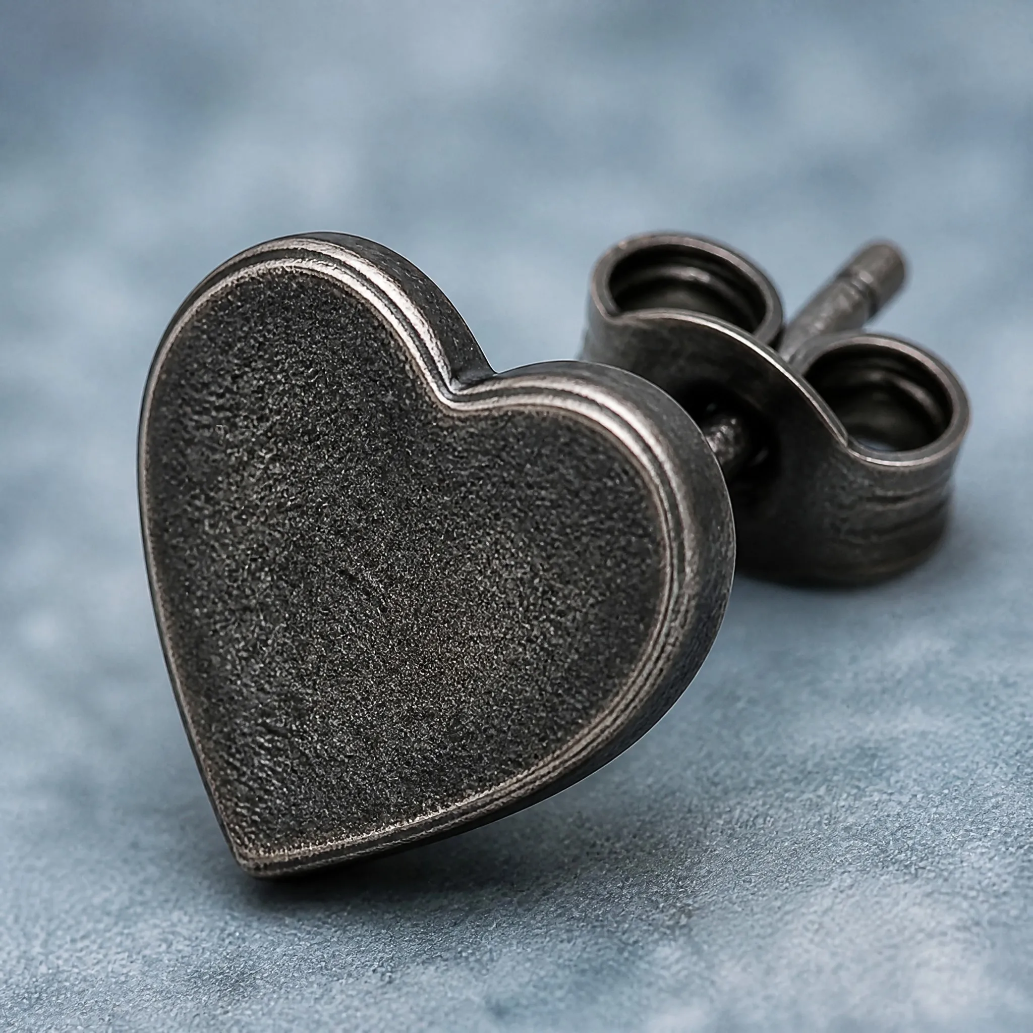 Oxidized black heart earring macro detail
