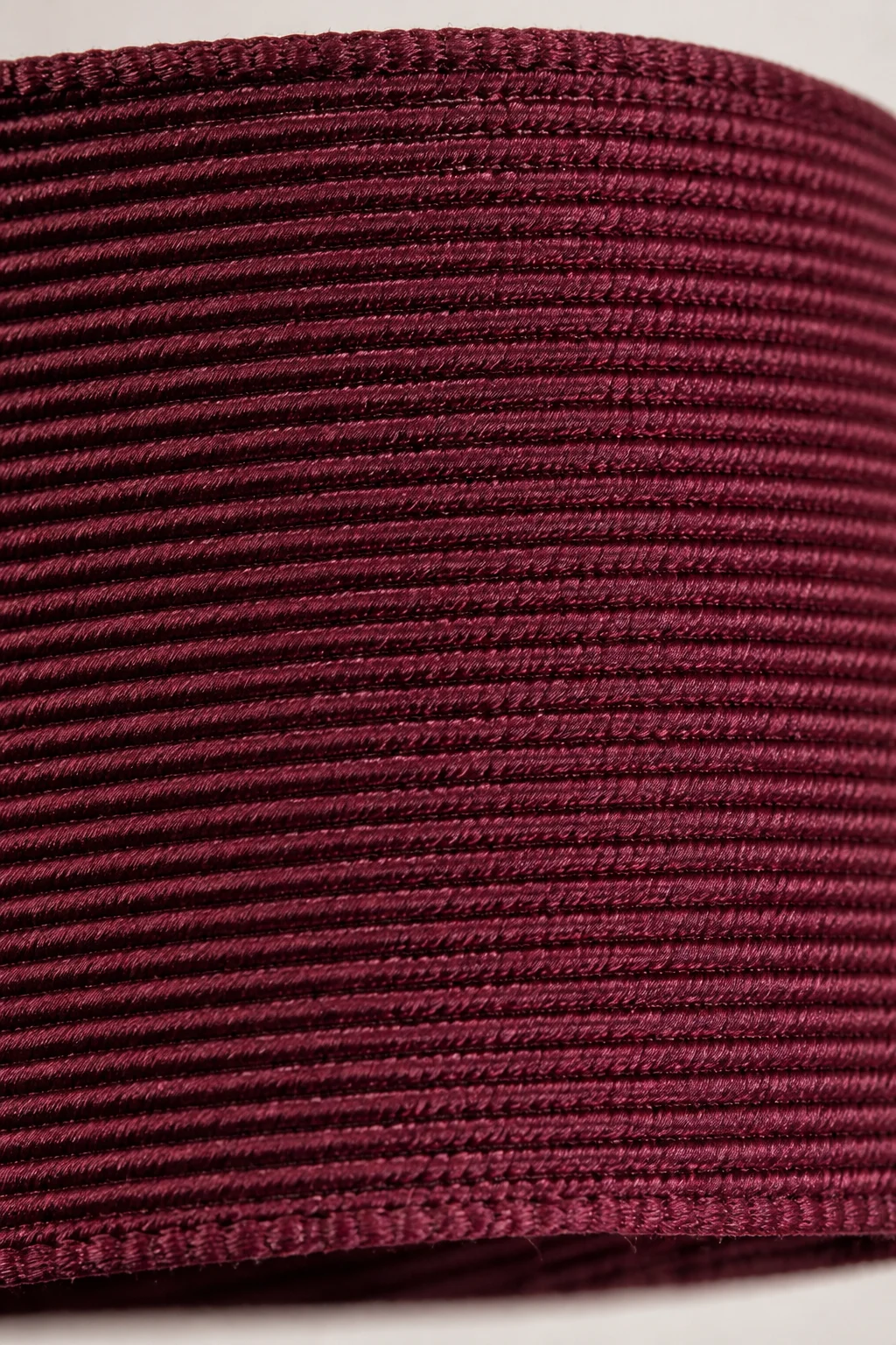 Close-up macro photo of grosgrain ribbon surface showing distinctive ribbed weave texture