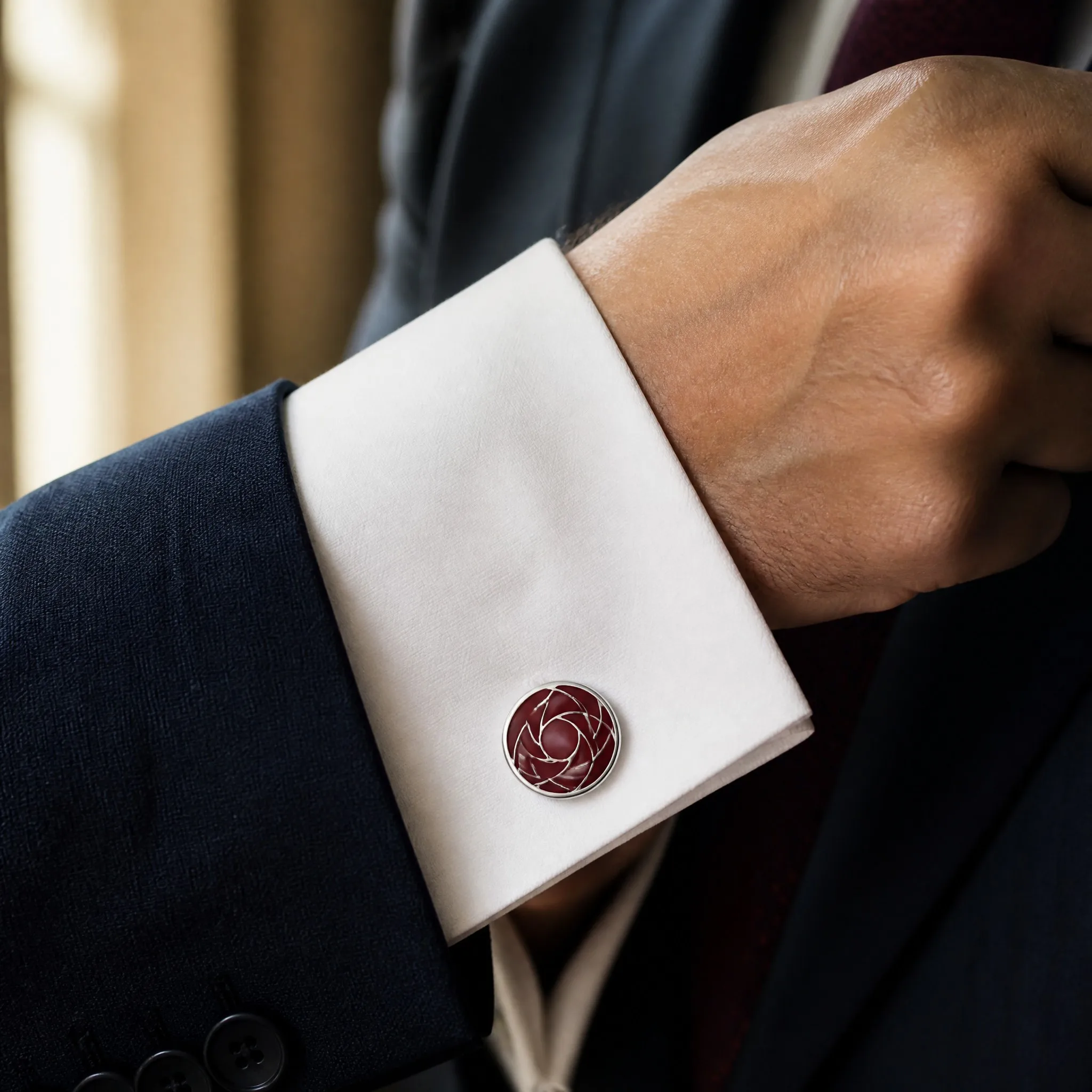 Burgundy soft enamel cufflinks worn on white dress shirt cuff
