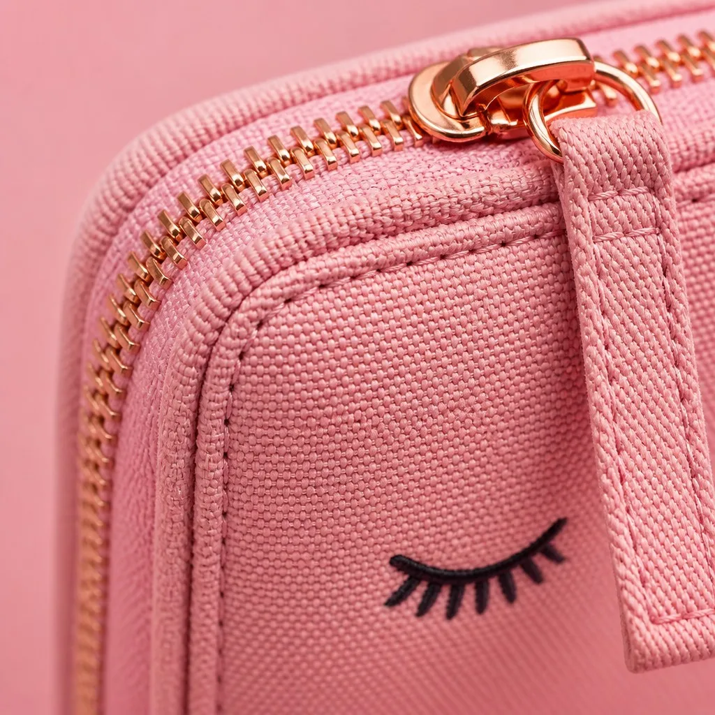 Macro of double-needle stitching, rose gold zipper and canvas weave on pink pencil pouch