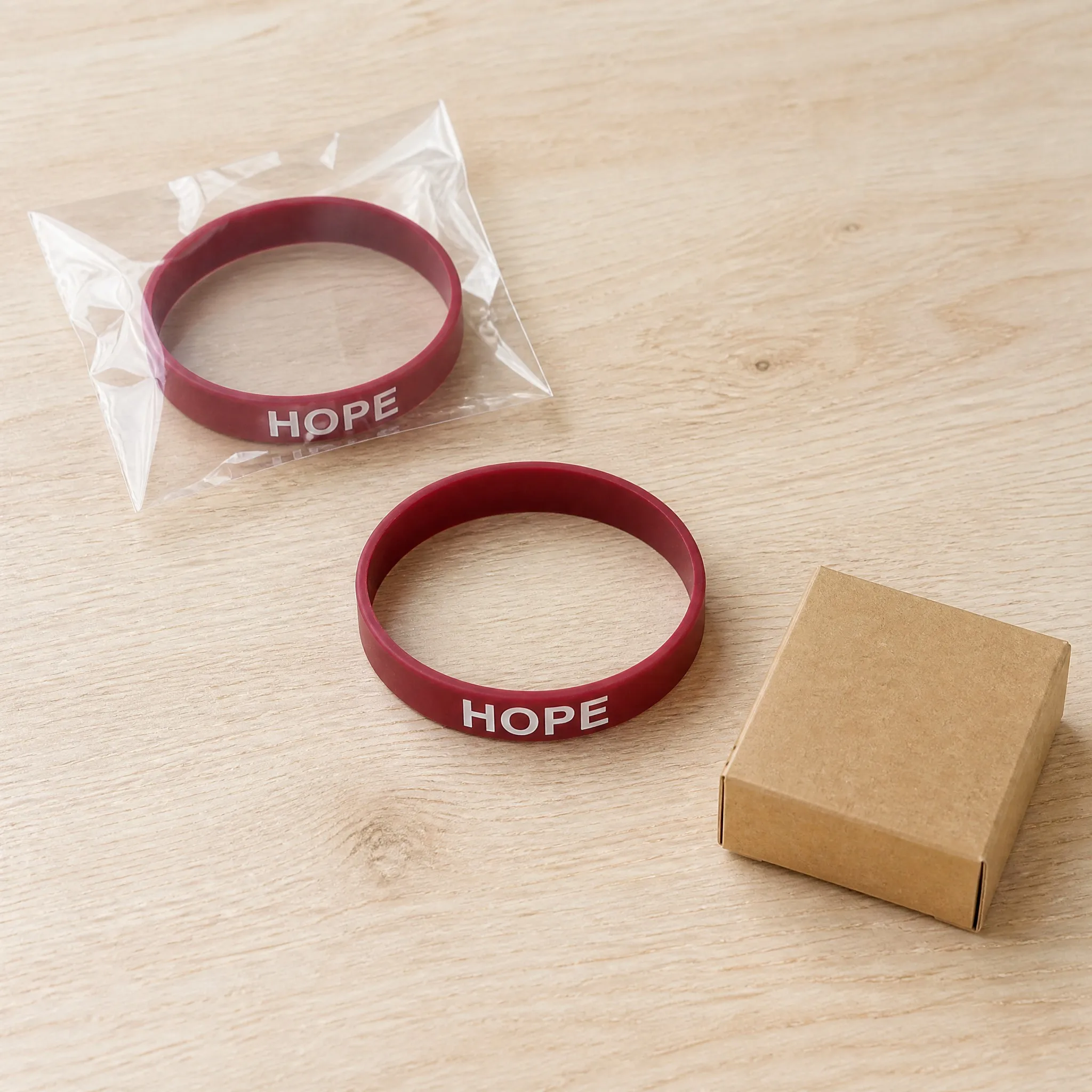 Silk screen printed silicone bracelets in OPP pouch and kraft box packaging