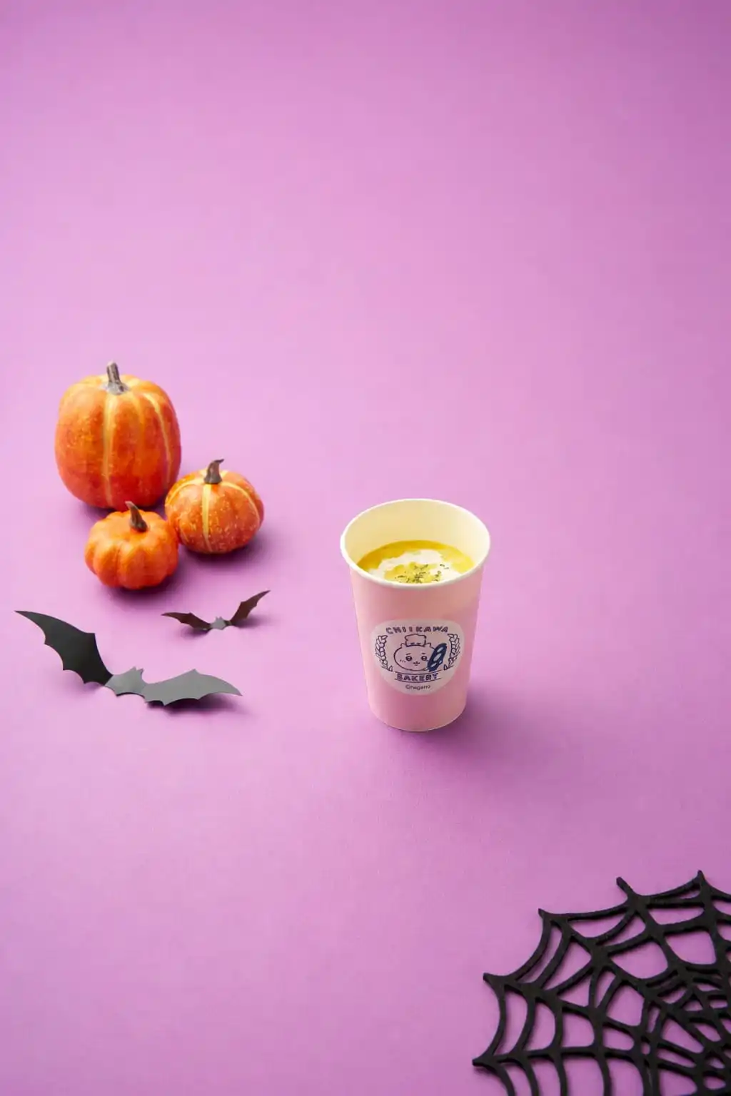 Chiikawa Bakery pumpkin soup in a branded cup with mini pumpkins, bat cut-outs and a paper cobweb