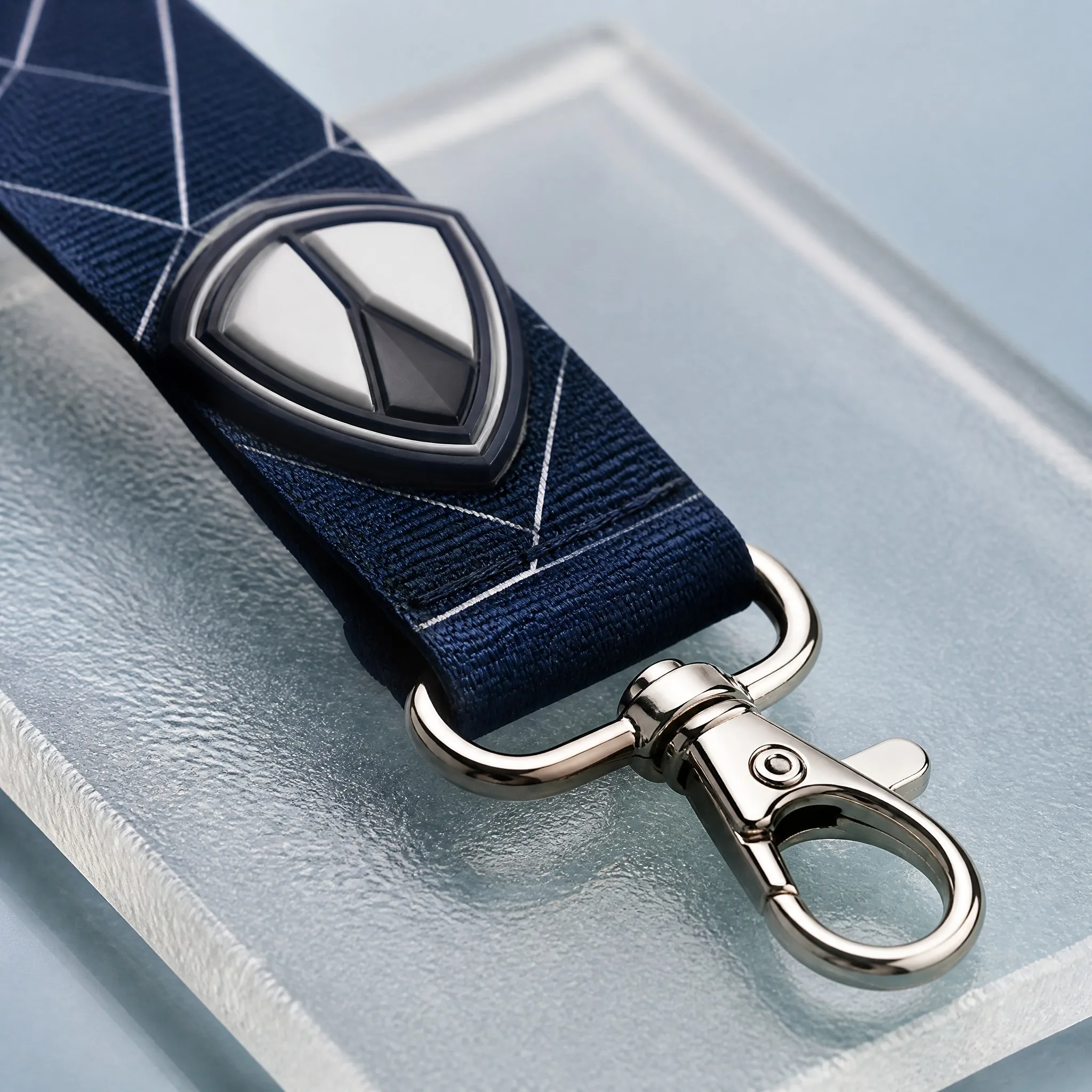 Close-up of raised 3D rubber shield emblem showing depth and polished metal clip