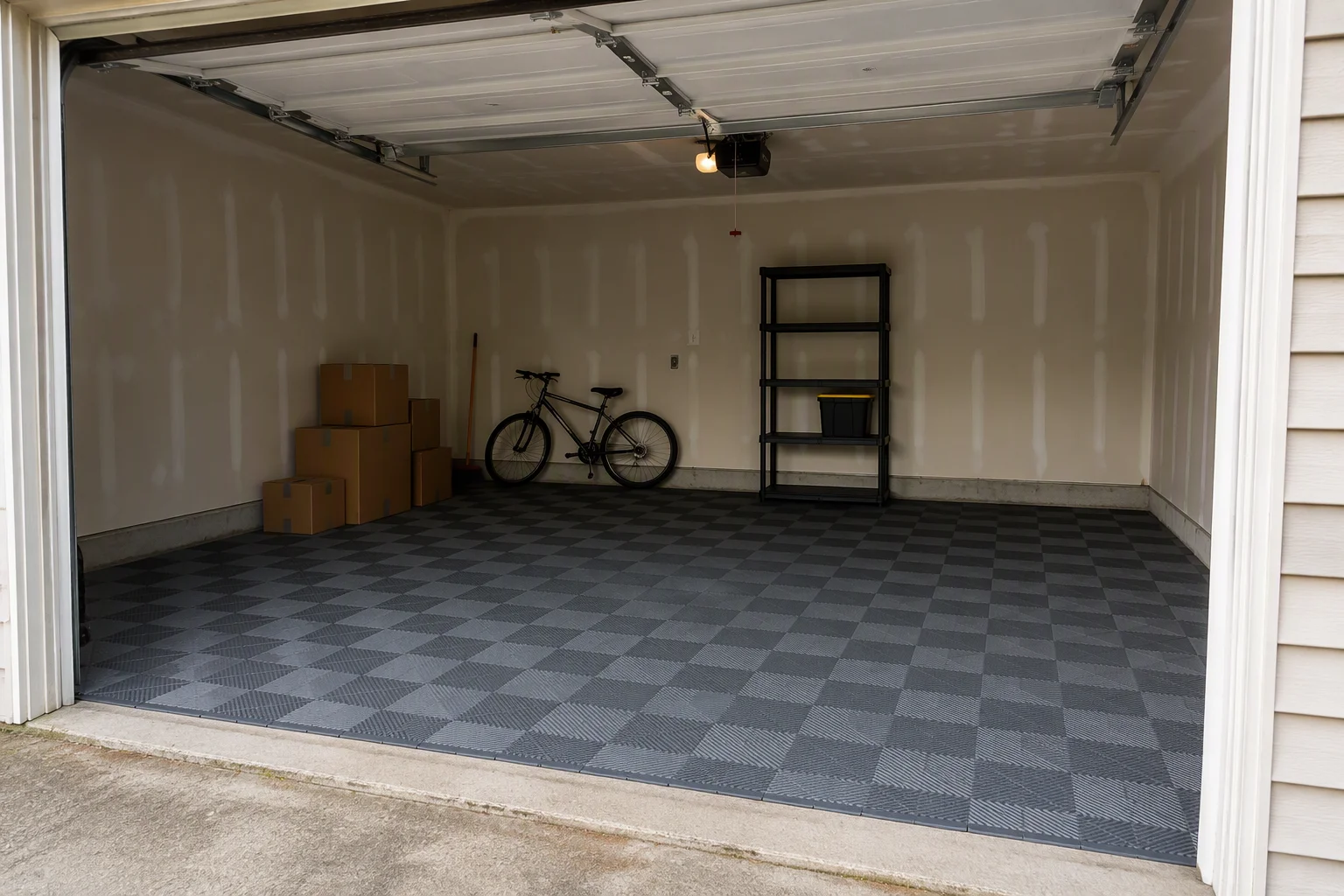 Interlocking garage floor tiles laid in a rented garage over an old concrete slab
