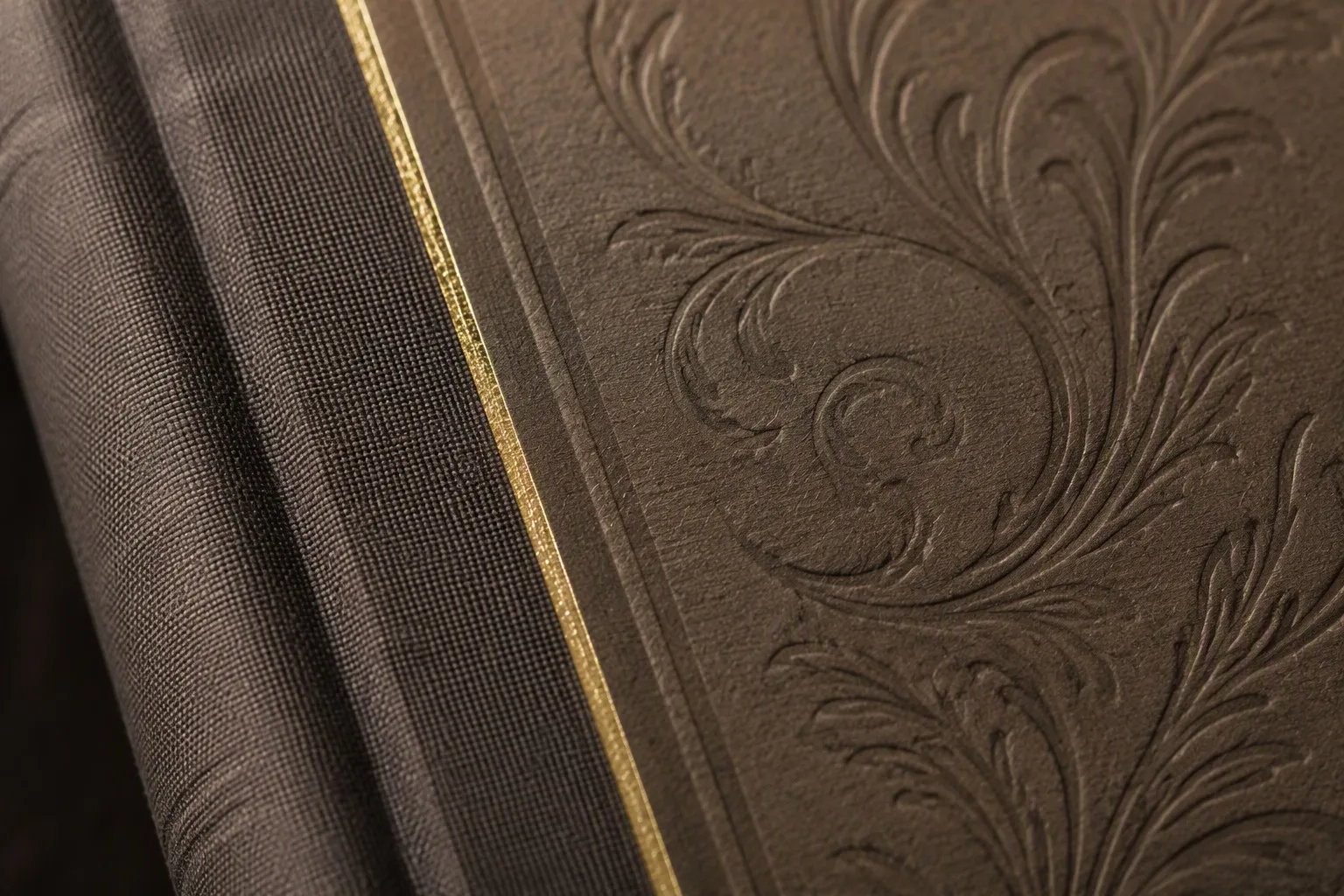 Hardcover book cover craft detail - cloth spine with gold foil and embossed pattern