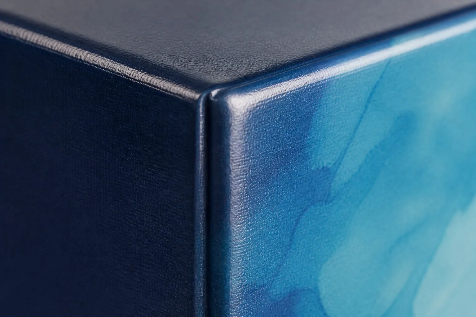 Close-up of crease cracking along score line on laminated book cover - film crack detail