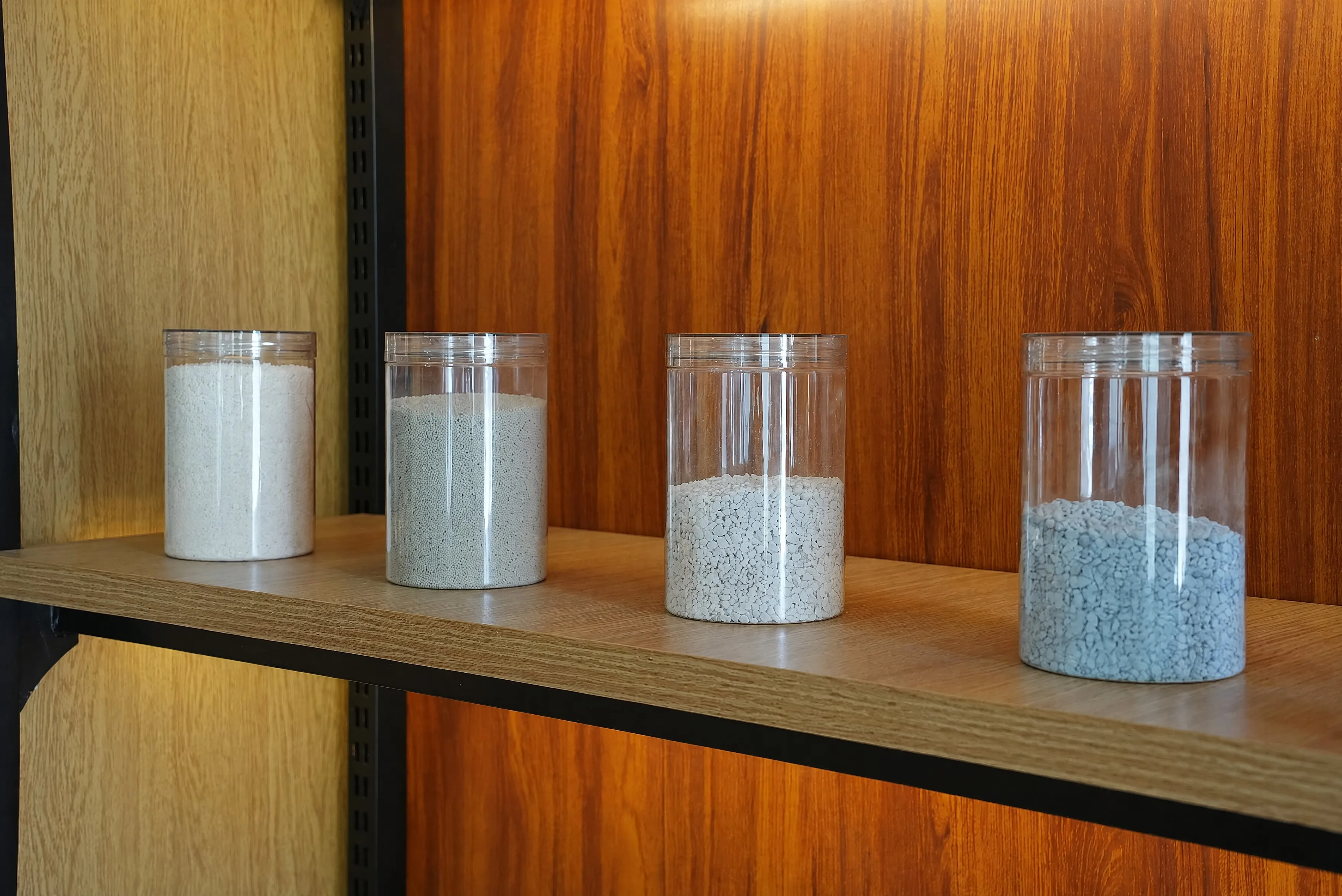 Zeolite granules and plant-based litter base materials in sample jars