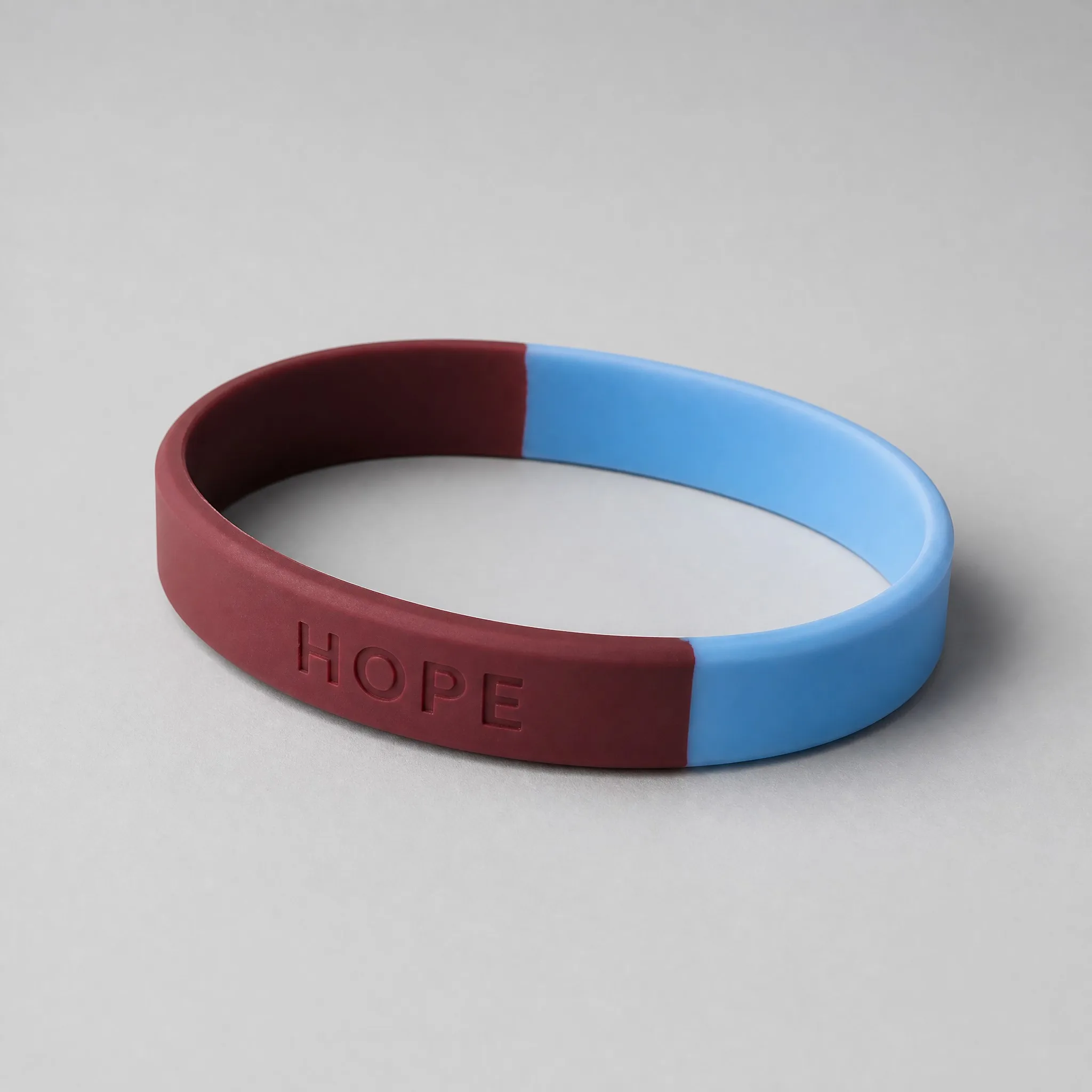 Three-quarter angle view of two-tone silicone bracelet
