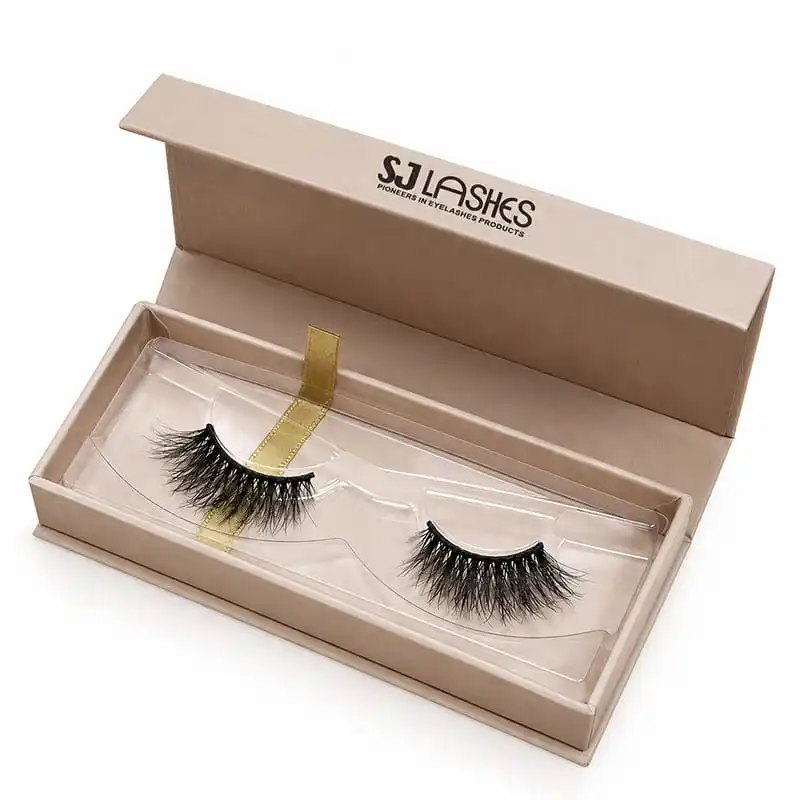 Open kraft single pair lash gift box with clear insert tray holding one pair of lashes and a gold ribbon pull tab under the tray, brand wordmark printed on the lid interior - kraft lash gift box with ribbon pull tab