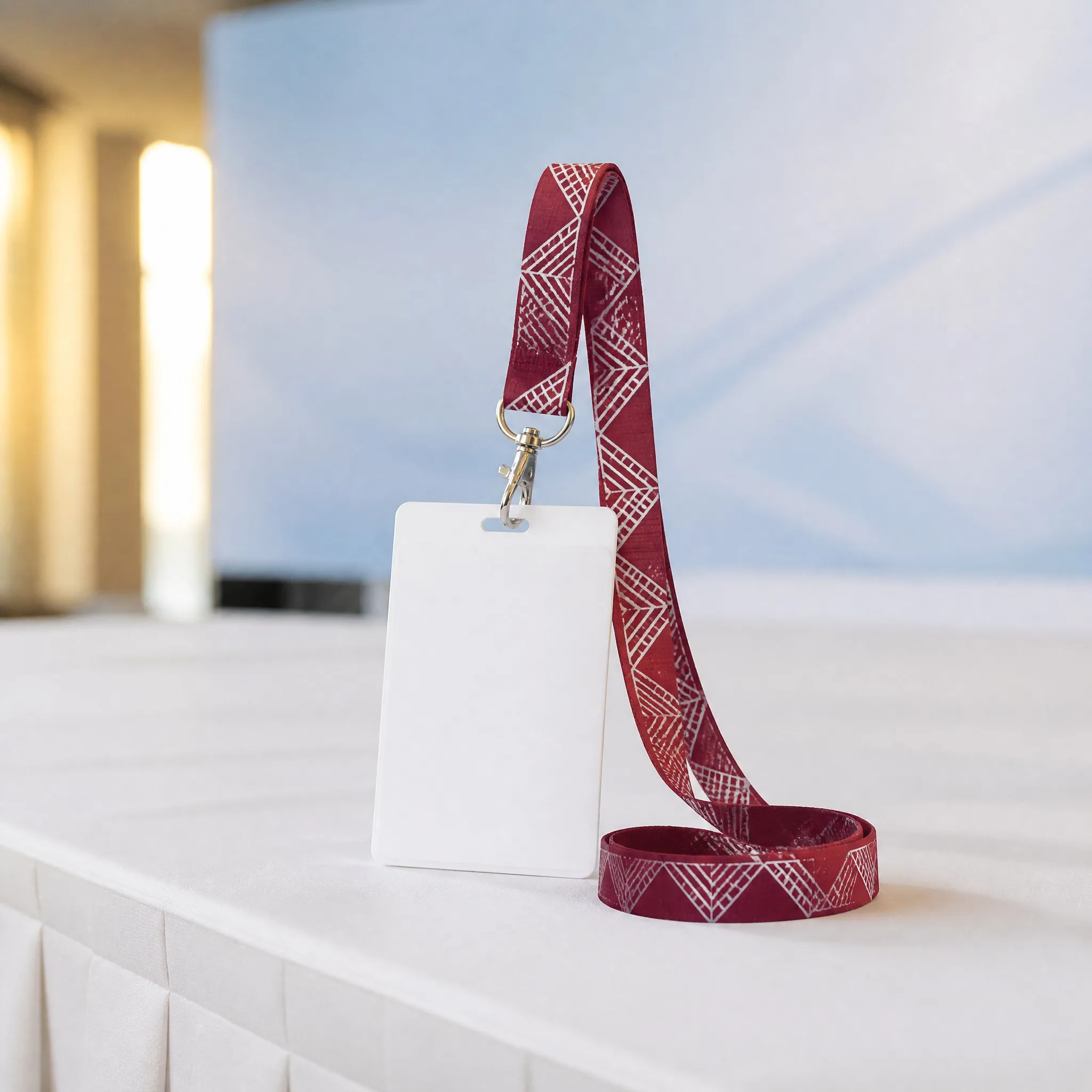 Lanyard hanging from conference ID badge holder at an event registration desk