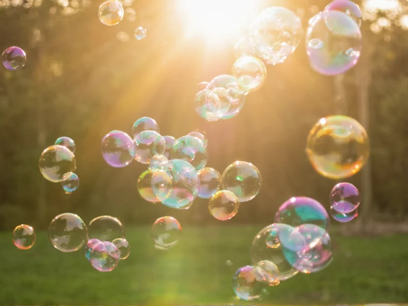 Colorful bubbles floating in sunlight