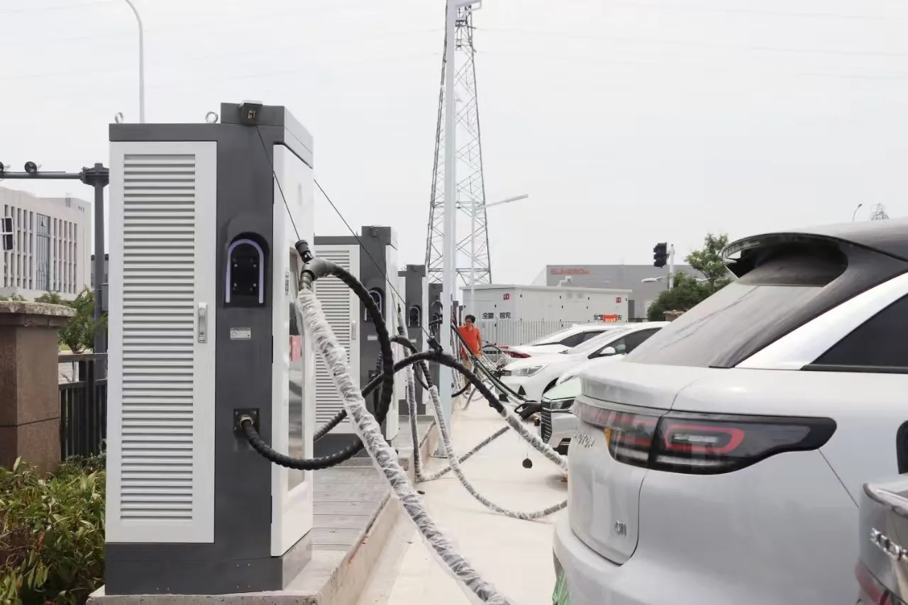 A multi-bay charging installation with overhead pulley cable retractors, suspended hoses and illuminated gun holster rings