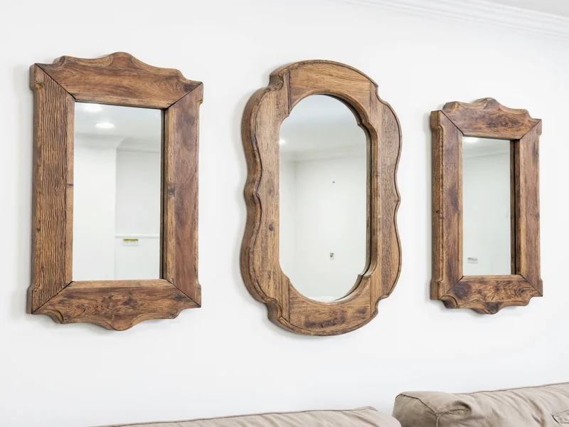 Three handcrafted mirrors with unique reclaimed material frames