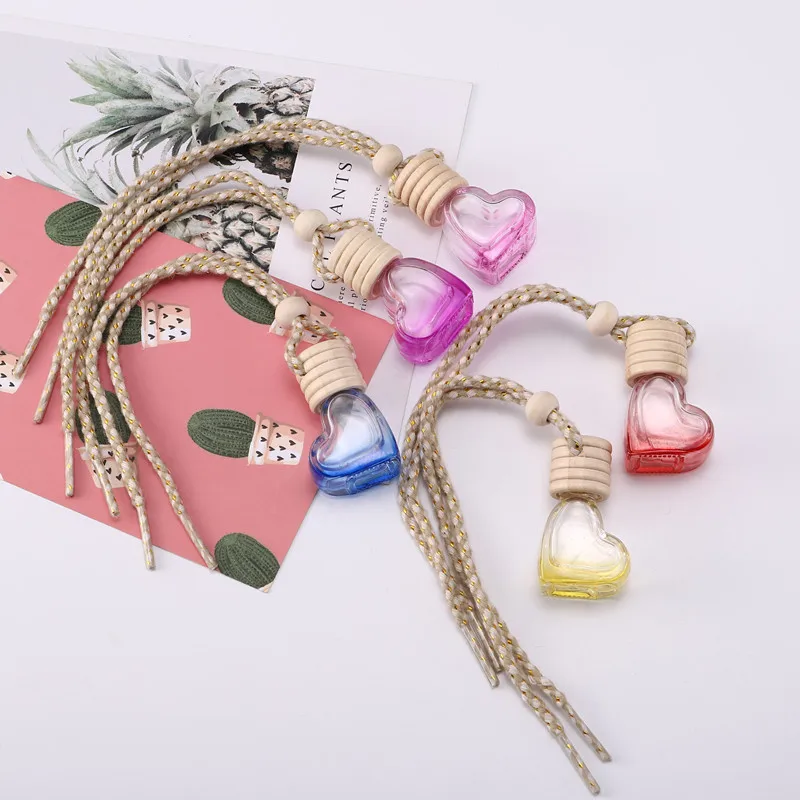 

Supply stock heart shape colorful glass car perfume bottle 5ml cosmetics empty car perfume bottle diffusers