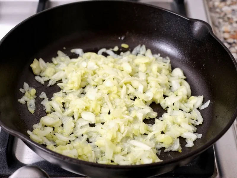 Chopped onions and garlic sizzling in cast iron pot