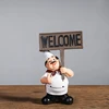 The cook held a sign with word in one hand handicraft home decoration small decorative articles