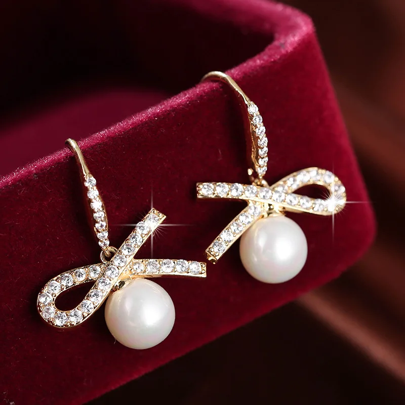 

Popular fashion bowknot Pearl Earrings copper inlaid Zircon Earrings versatile temperament sweet jewelry