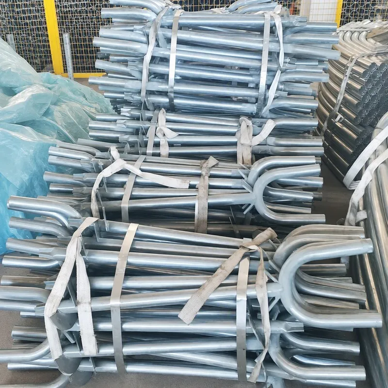 Curved galvanized greenhouse frame components bundled at the JYXD factory.