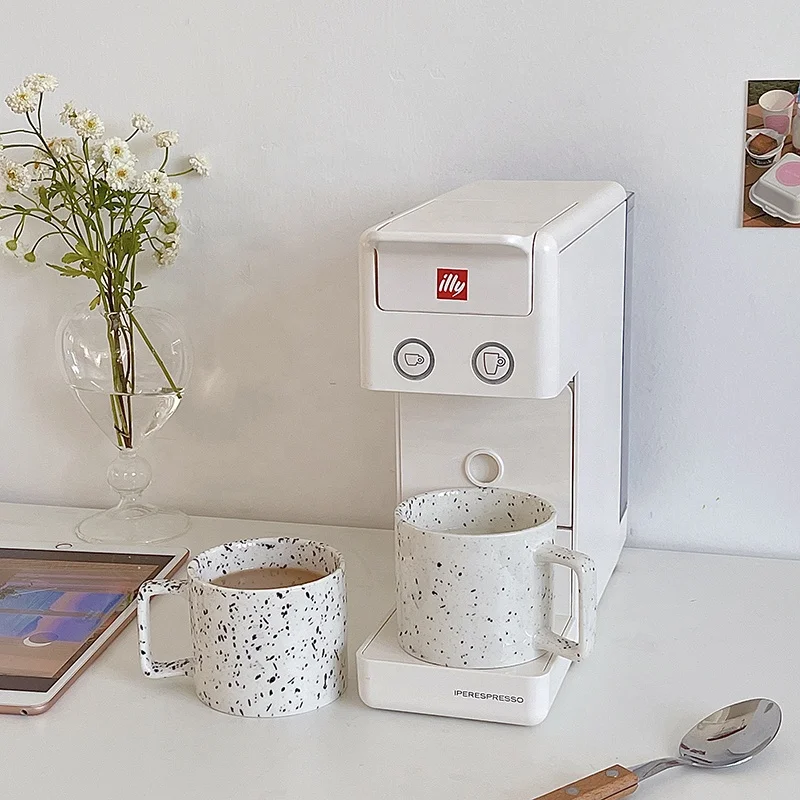 

Ceramic Speckled Mug with black speckled print on a neutral beige base cup colour with Comfortable square handle., As pictures