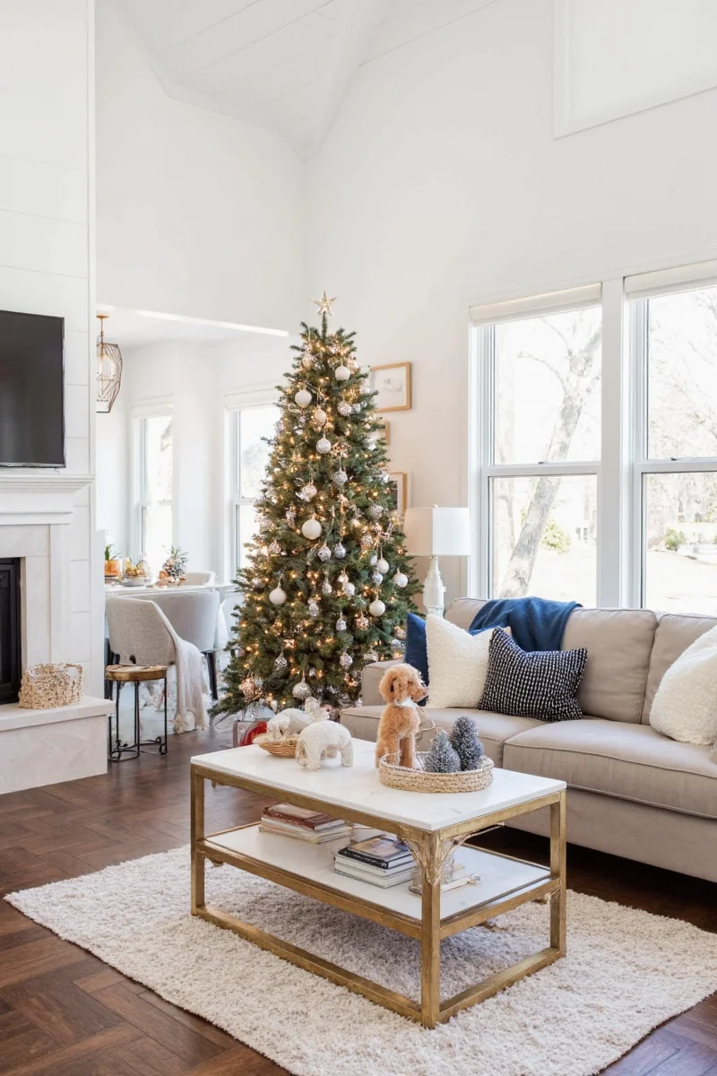 Cozy living room with holiday decor, fireplace, and family gathered around