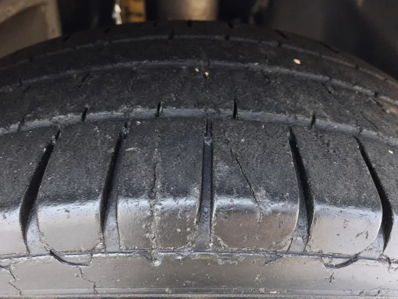 Close-up of uneven tire wear from misalignment