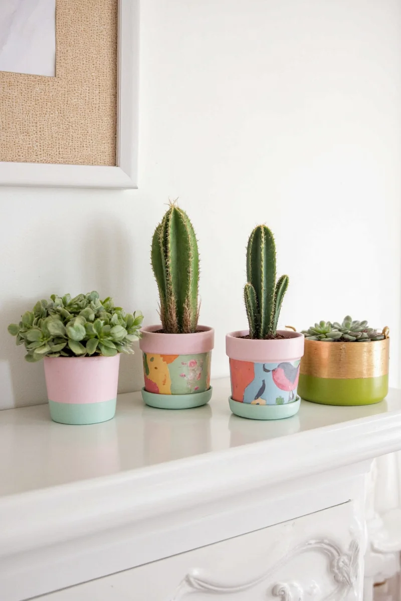 Cute painted pots with smiling faces and colorful patterns