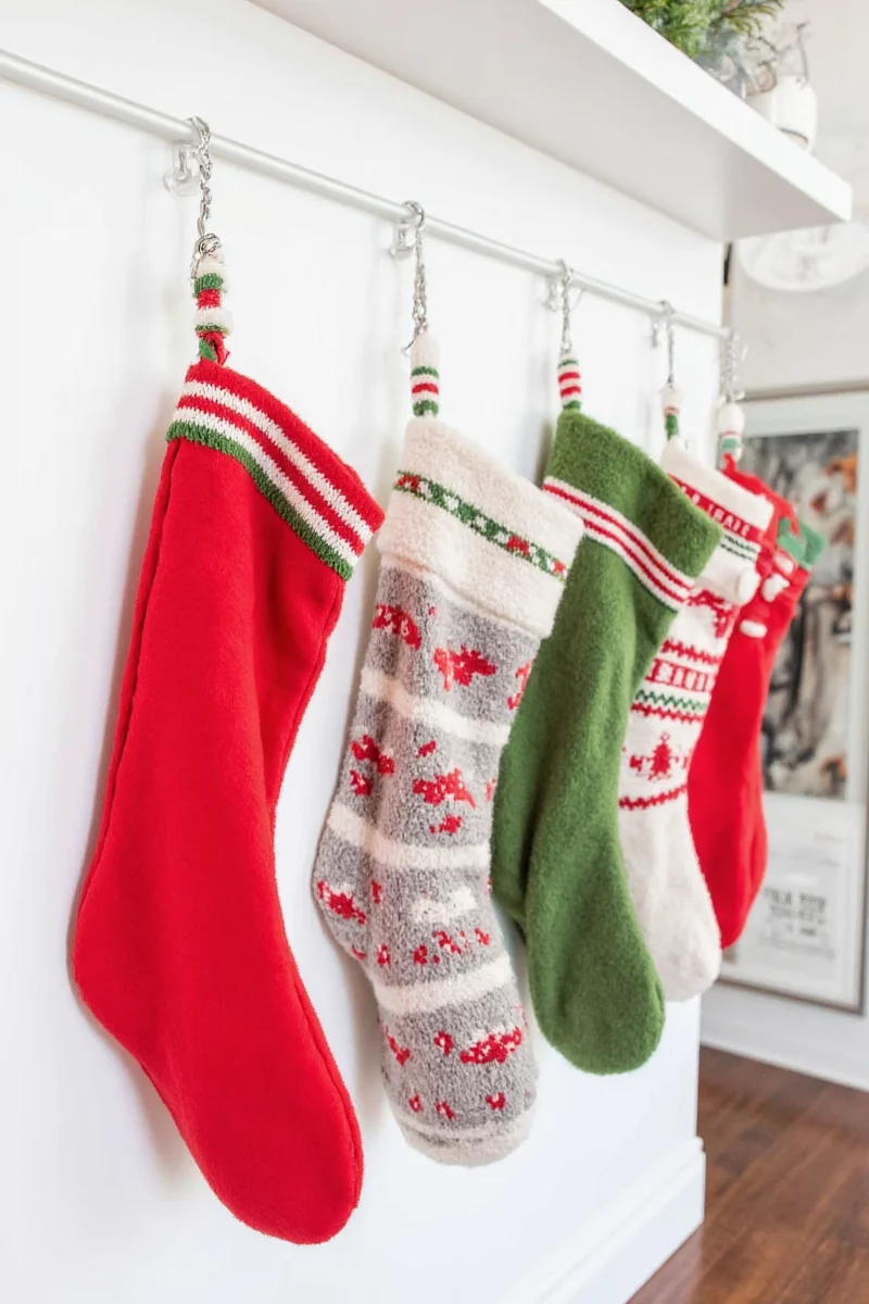 Suction cup holders attached to shower tiles with cute holiday stockings