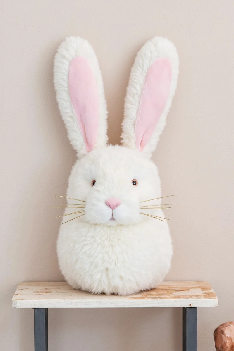 A ceramic lamp in the shape of a sitting rabbit casting soft golden light