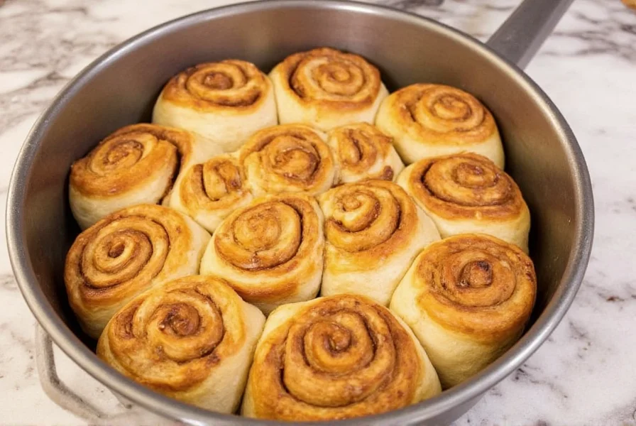 Rhodes frozen cinnamon rolls in baking pan with caramel sauce before baking