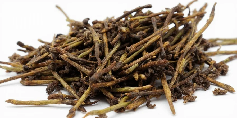 Spice vendor holding a handful of nigella pods
