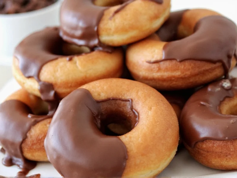 Homemade donuts dipped in glossy chocolate glaze