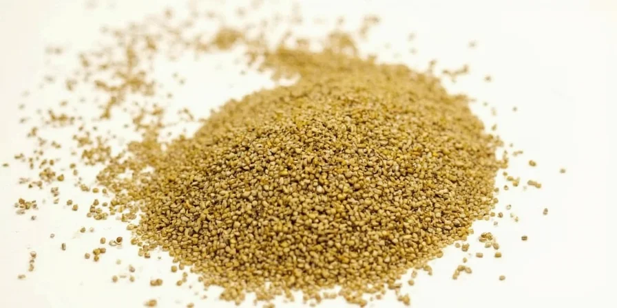 A chef adding mustard seeds to a hot pan