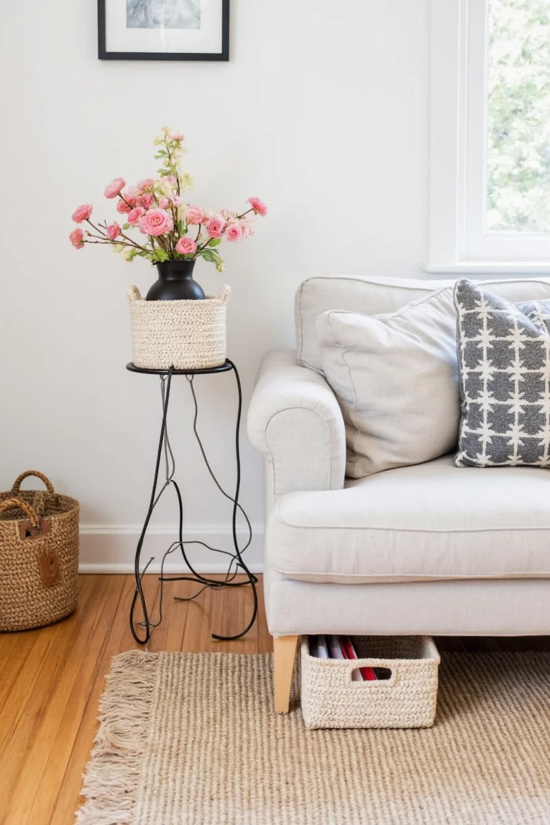 Crate and Barrel ottoman with hidden basket and cord cutout