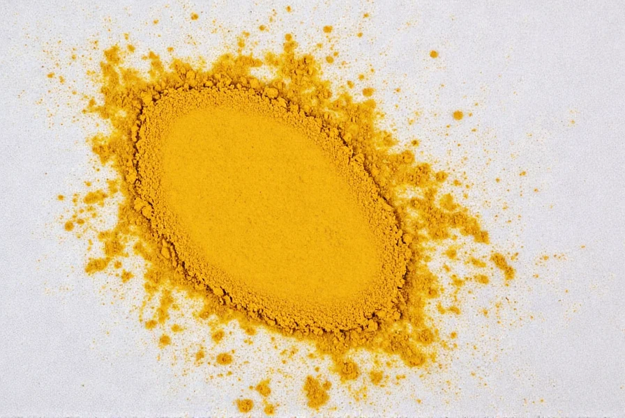 Close-up of turmeric powder spilling on white cotton fabric showing initial stain formation