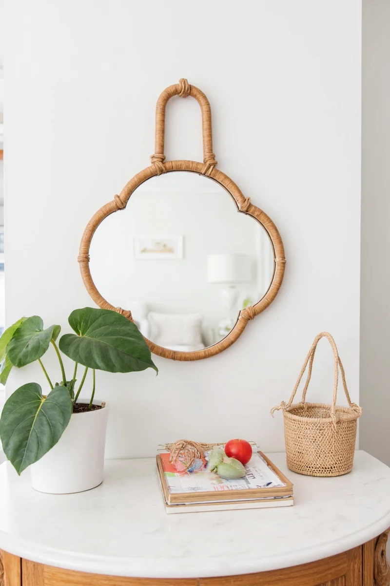 Family standing in front of a rattan scallop mirror in a sunlit living room