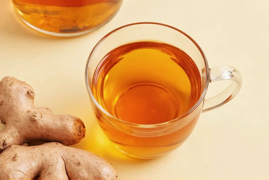 Fresh ginger root slices steeping in clear teapot