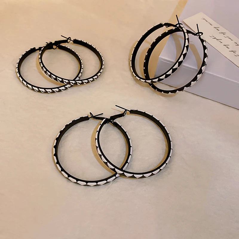 

black white hoop earring with leather laces