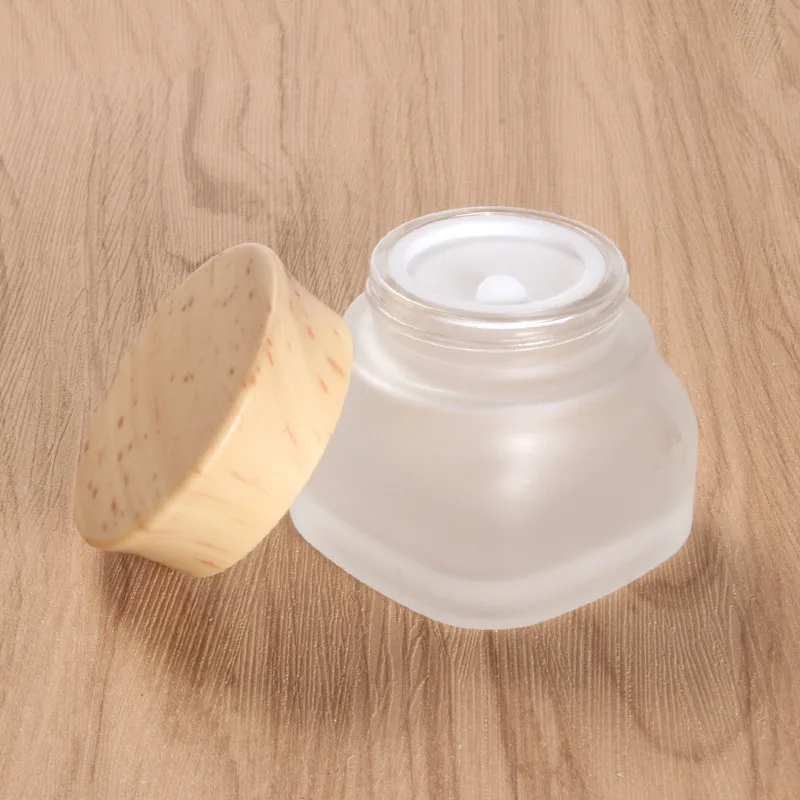 

Low MOQ 50g square cosmetic jar with wooden lid frosted cosmetic packaging jars glass wide mouth cream jar